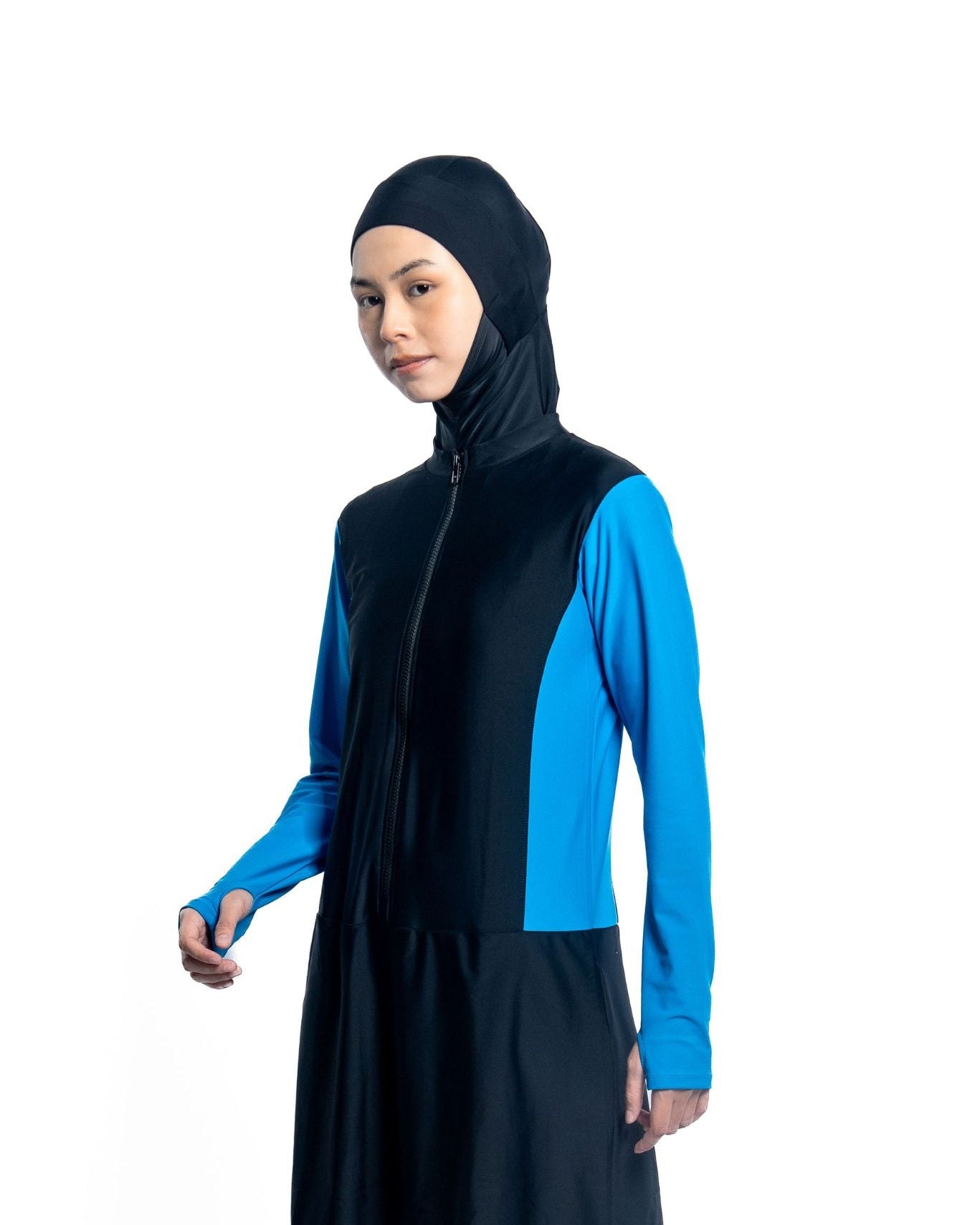 Person wearing a black and blue long-sleeve Modest Swimwear Top on a white background